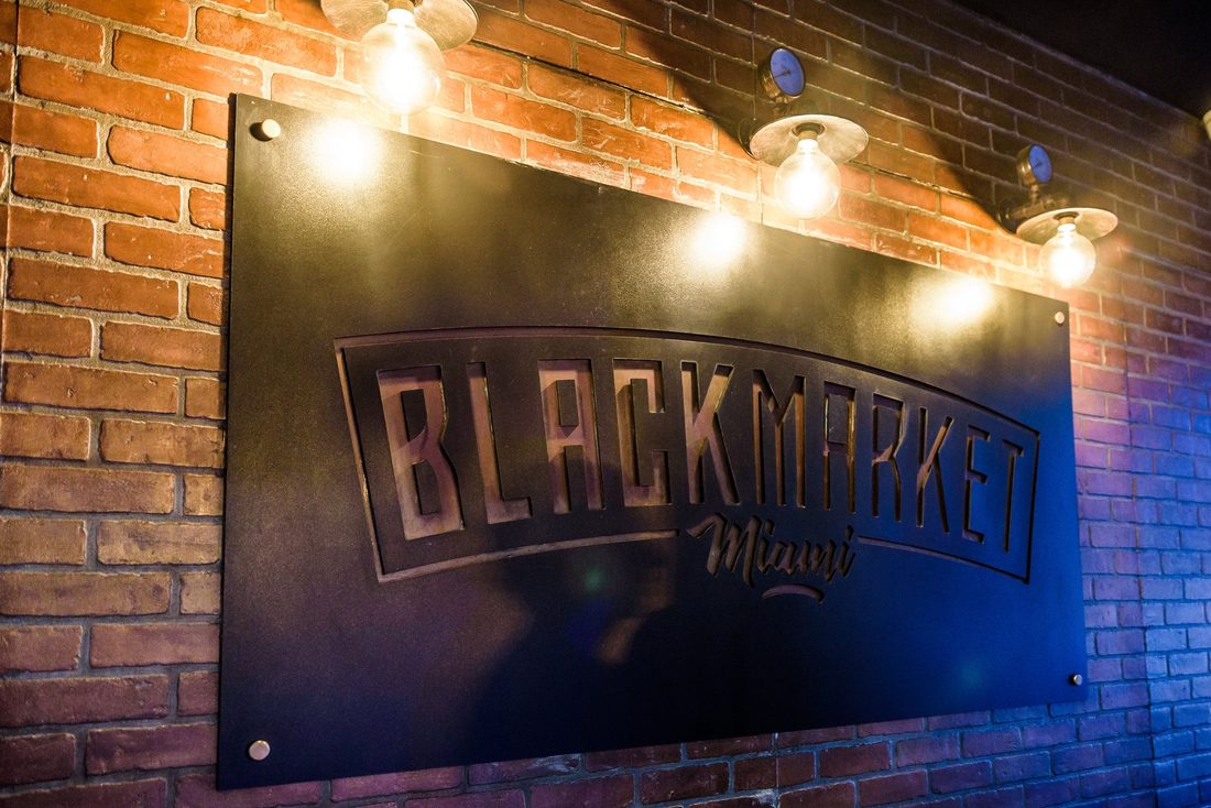 BLACKMARKET Miami metal signage on brick