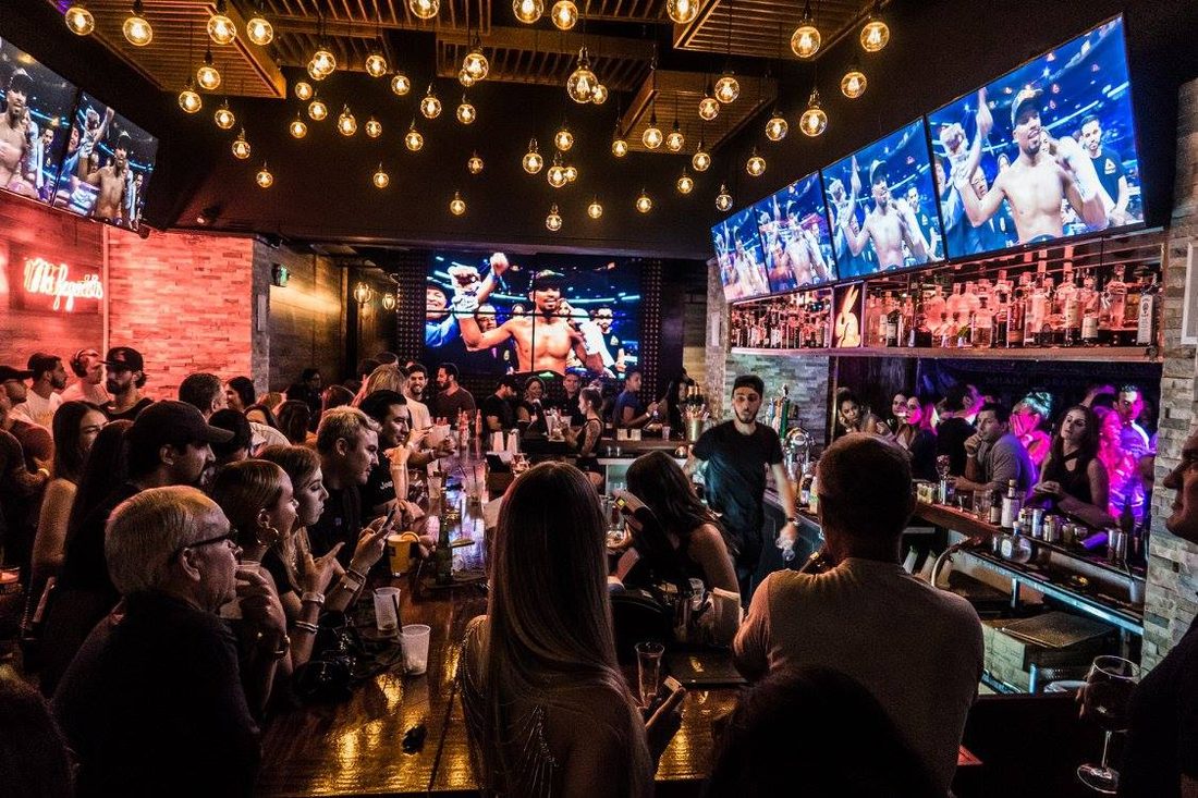 Black Market interior with crowd and overhead bulb canopy