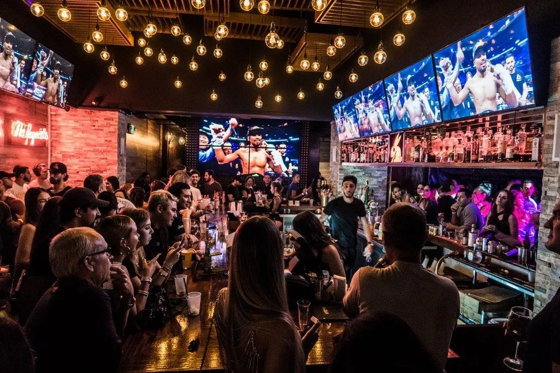 Black Market interior with crowd and overhead bulb canopy