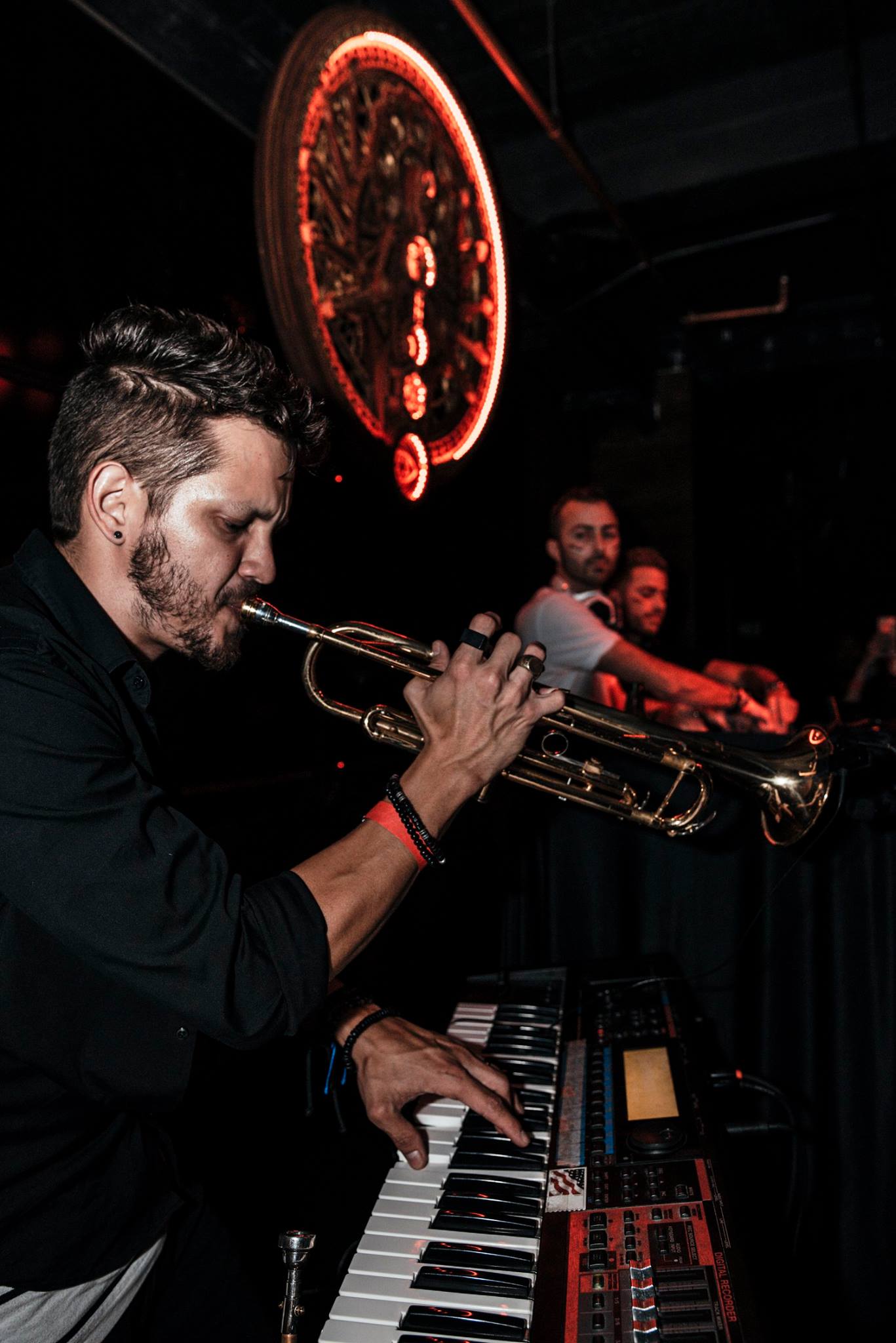 Live trumpet player performing over the DJ set