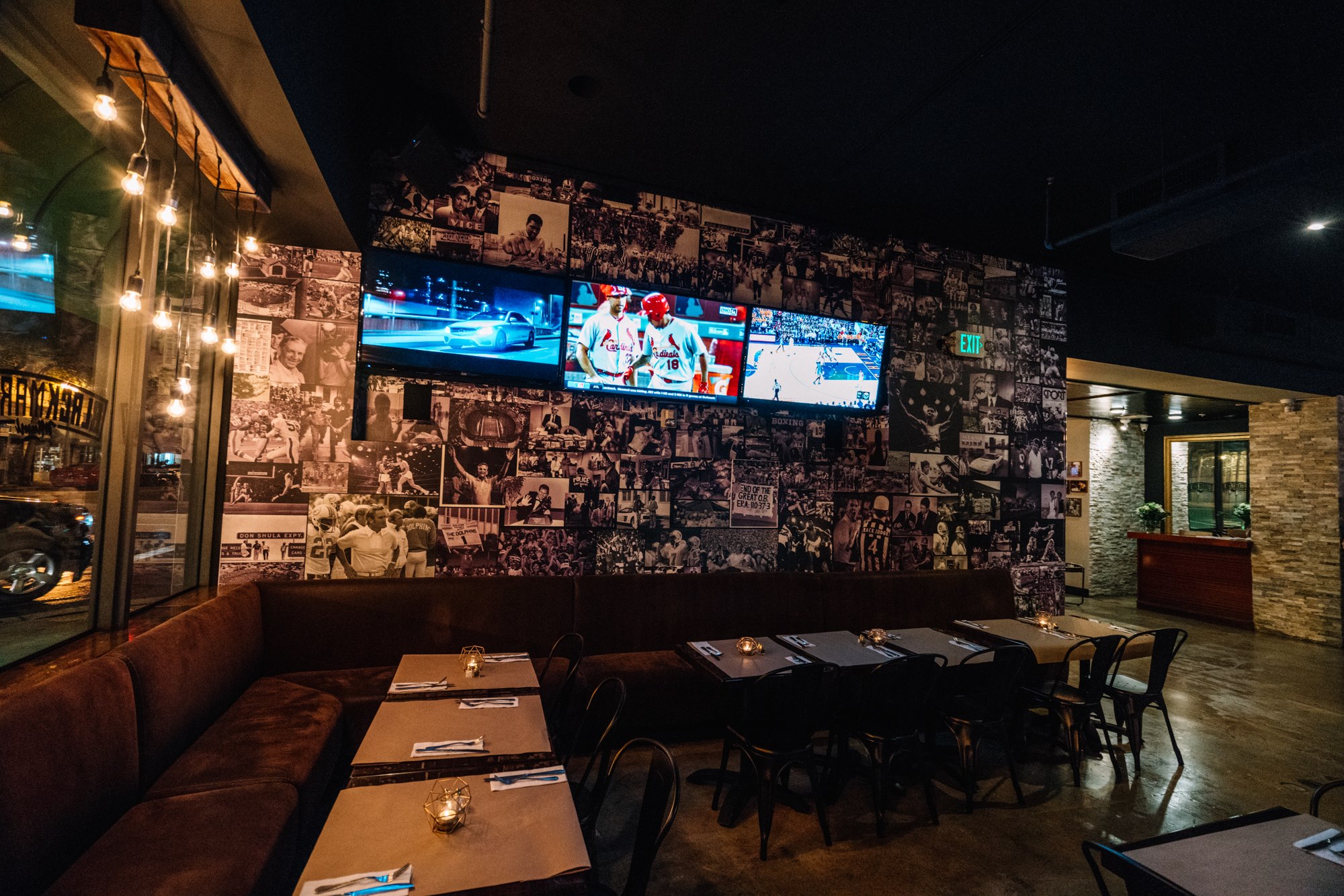 Dining room against the black-and-white sports photo-collage wall