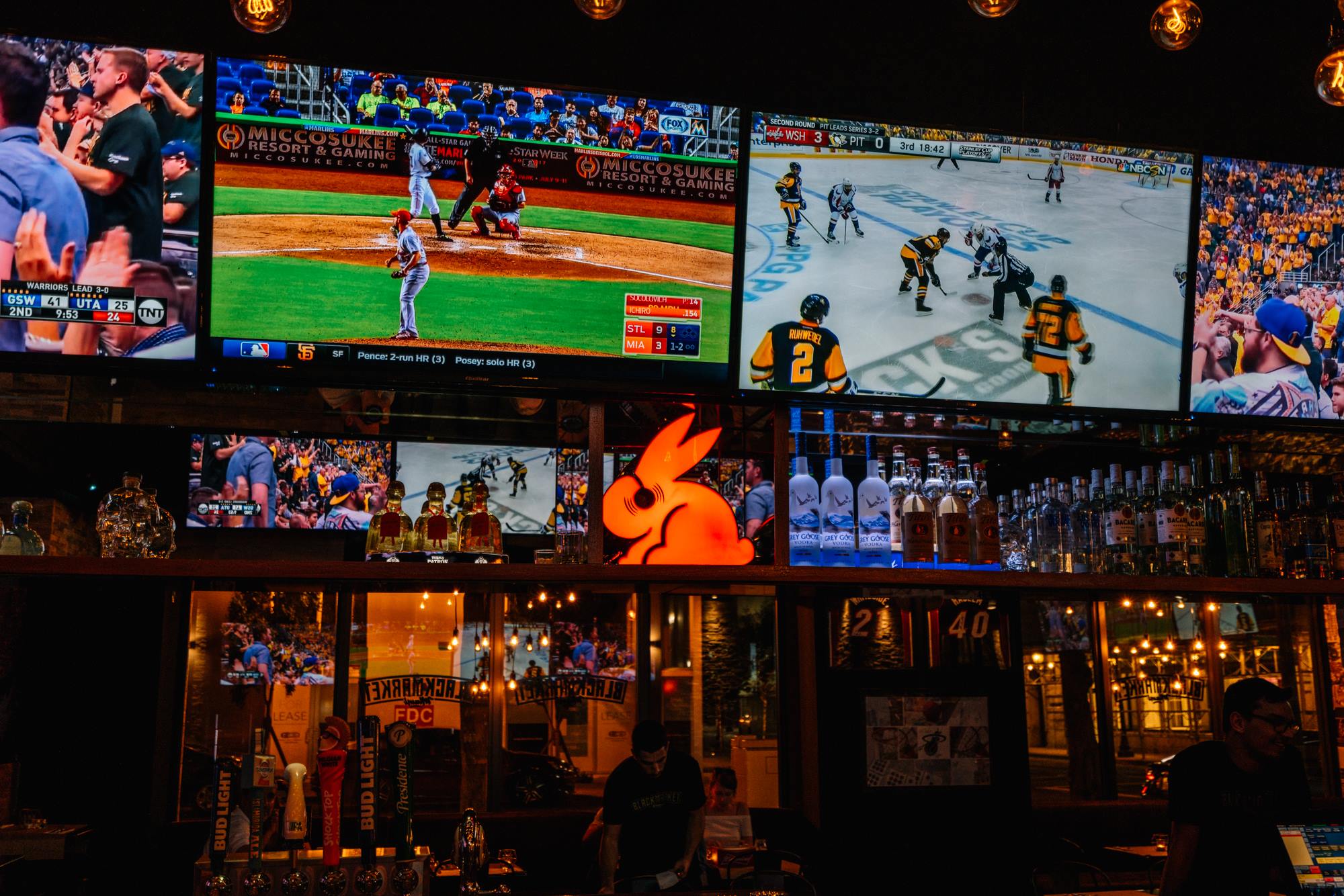 Bar-top video wall stacked with live baseball and hockey