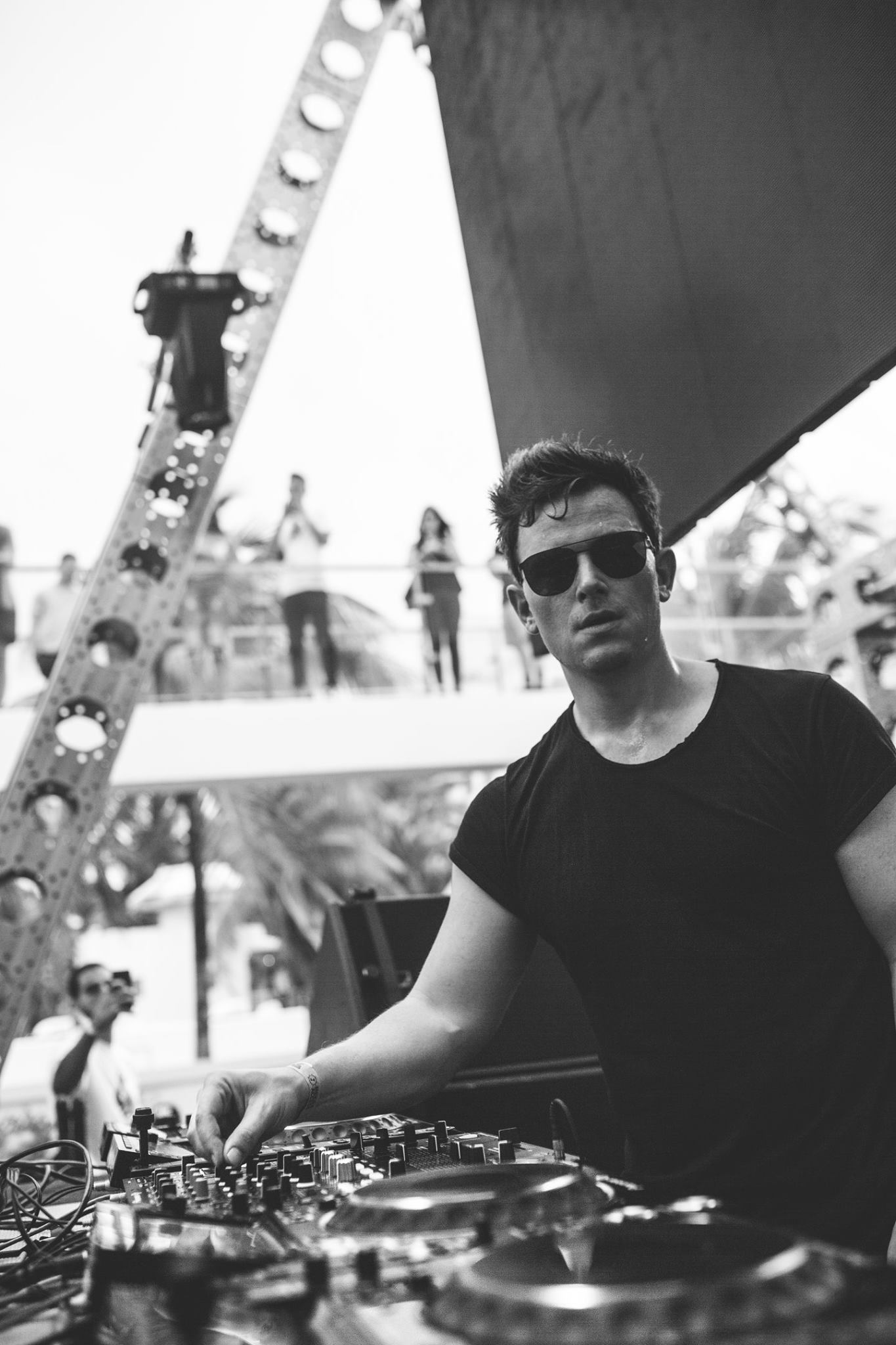 Guests dancing poolside during a daytime set