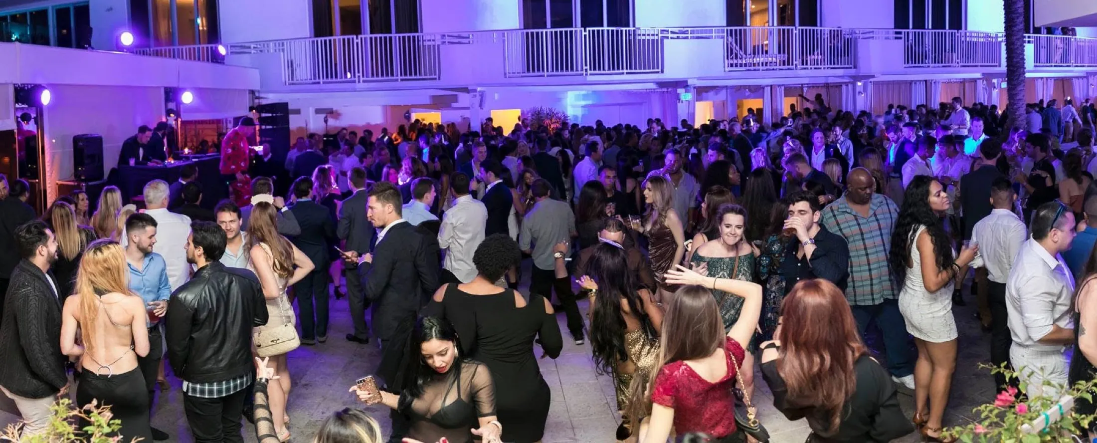 The courtyard dancefloor at full capacity under purple light