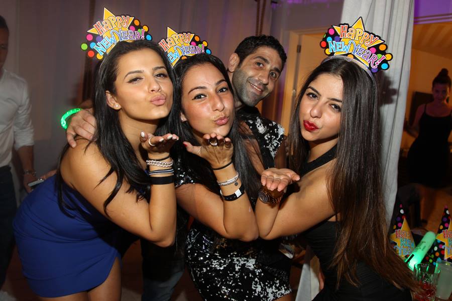 Guests in star-shaped Happy New Year tiaras blowing kisses to the camera