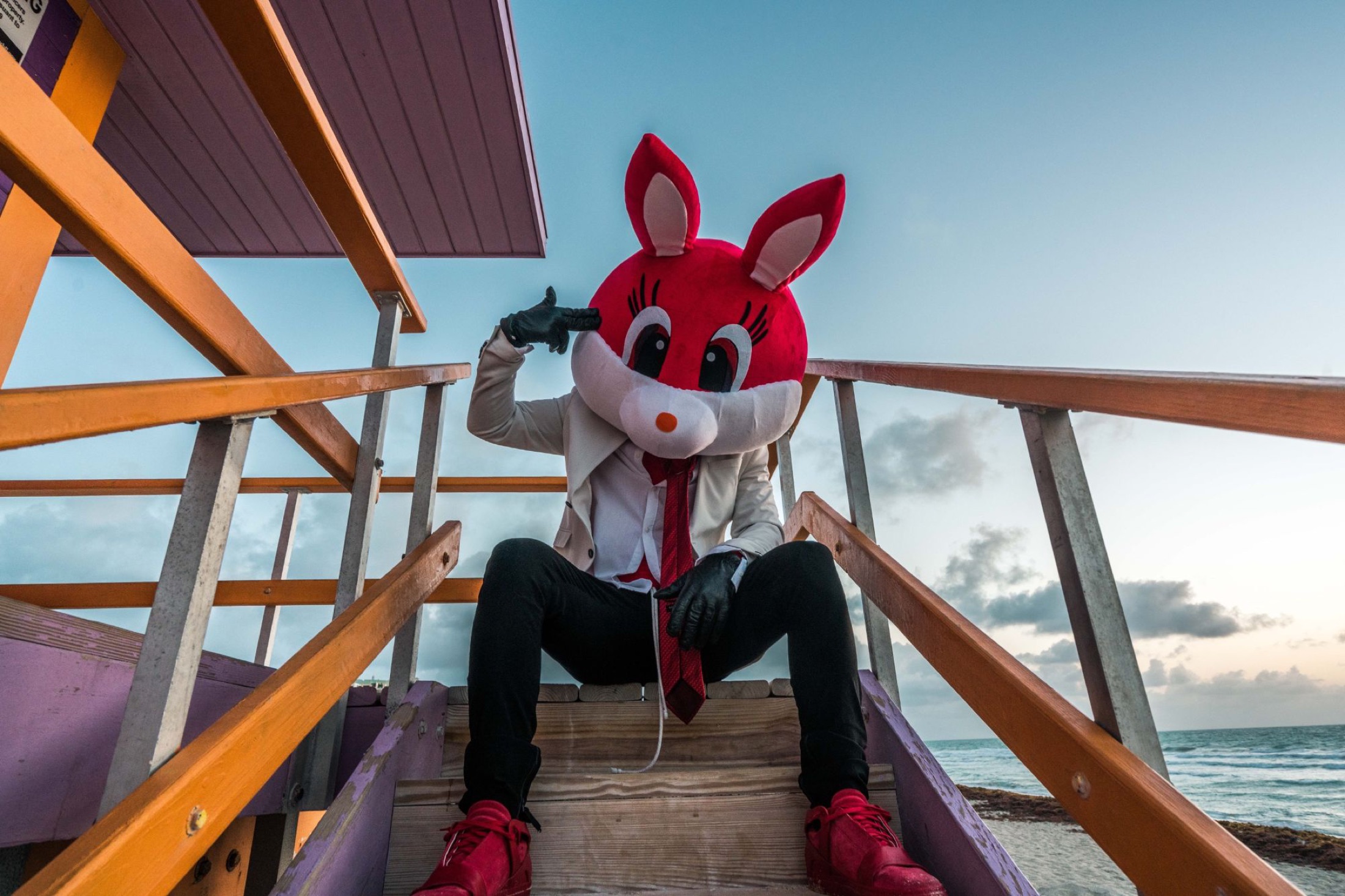 The Red Rabbit mascot holding down a South Beach lifeguard tower at dawn