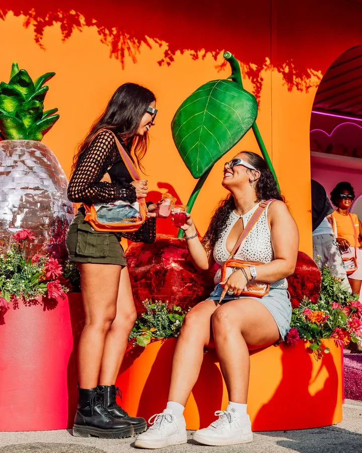 Friends posing on the Dunkin’ pineapple-garden set