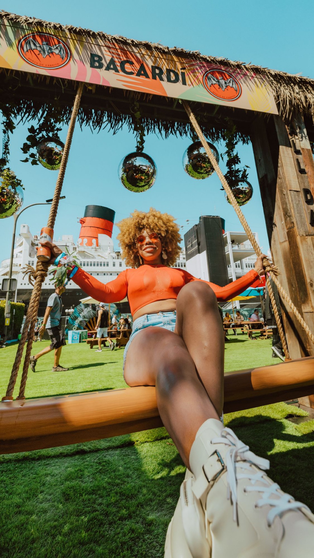 Bacard&iacute; disco-ball swing set against the Queen Mary at Day Trip